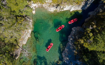 Aerial shot of Funyaks on the Dart River exploring the chasms