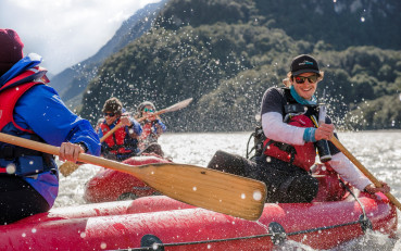 Funyak guide paddling through the Dart River on inflatable kayak