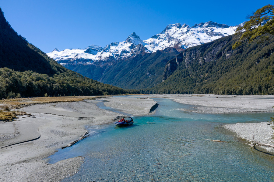 Wilderness Jet boat on the Dart River in Mount Aspiring National Park with mountains in the background