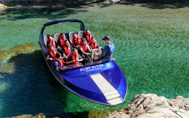 Guide talking to passengers on a Wilderness Jet boat in Glenorchy