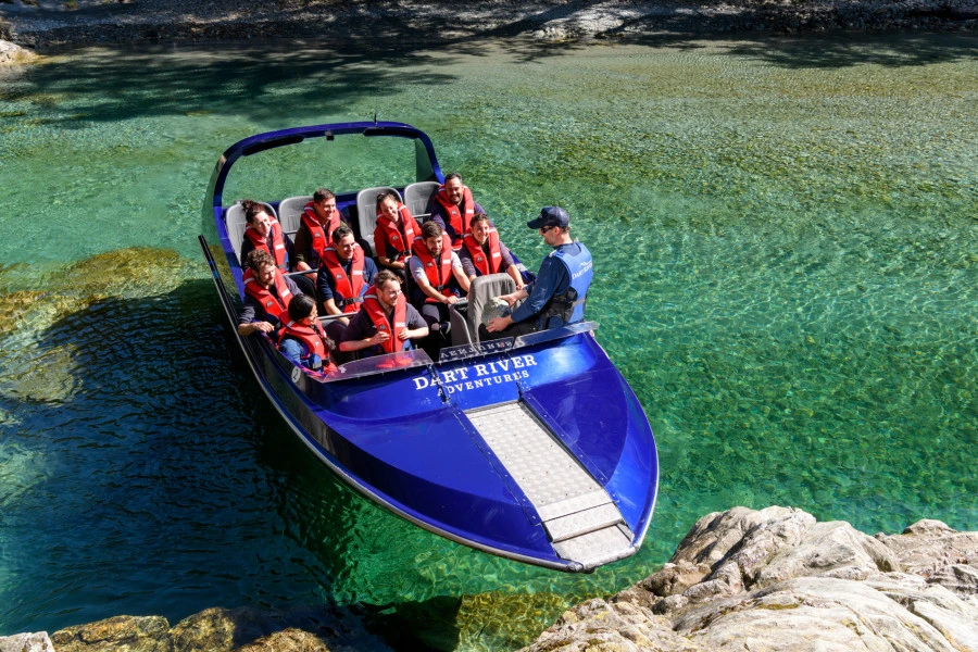 Blue jet boat stopped in clear water 